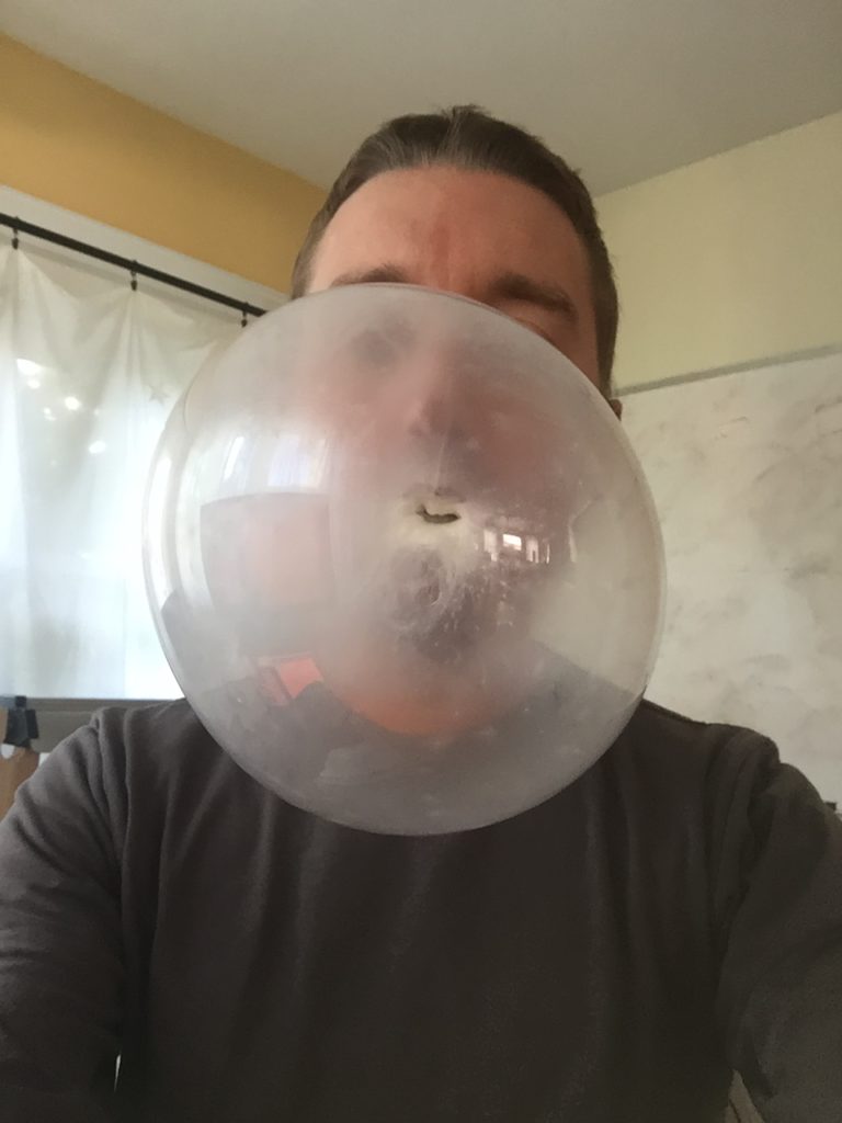 A close up shot of a large bubble gum bubble