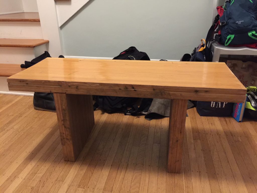 A wooden bench made from bowling alley floor