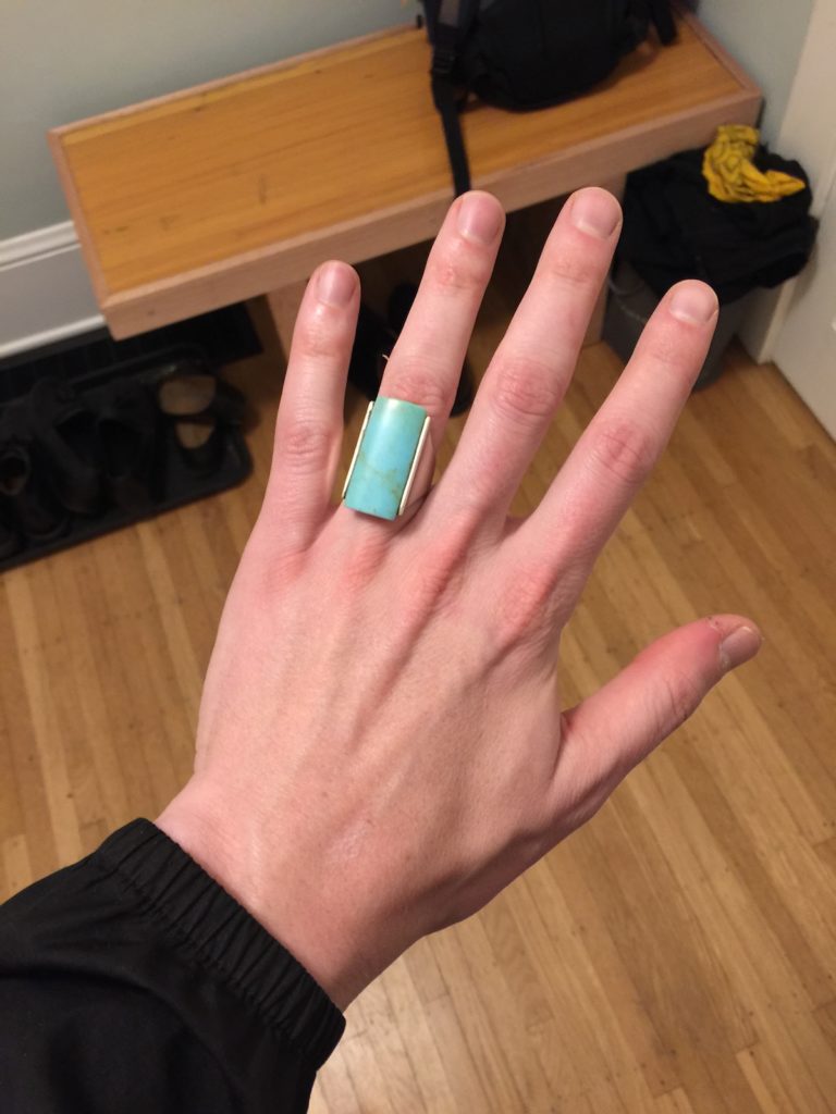 A clunky turquoise ring on my finger